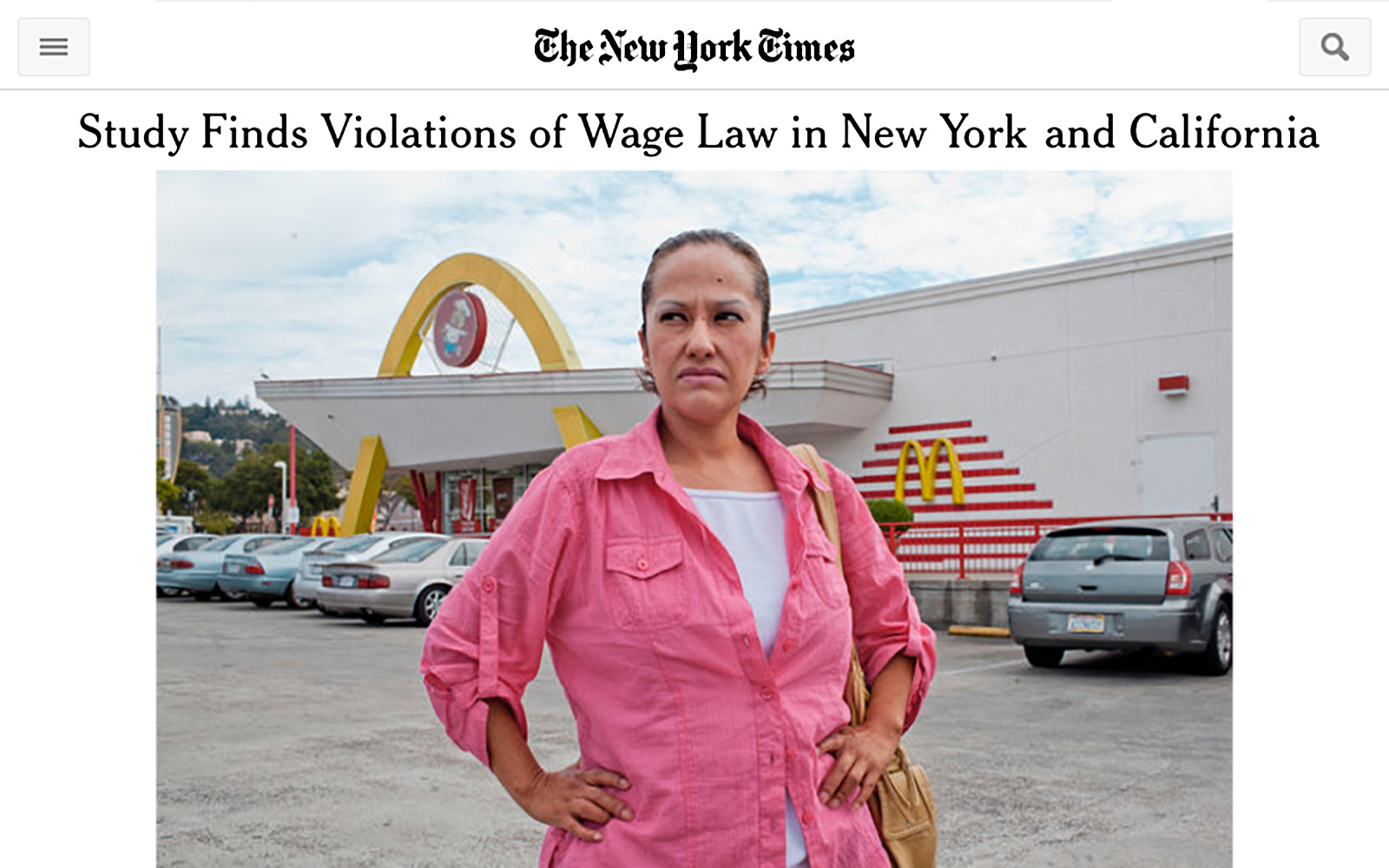 Screenshot of online New York Times page with headline "Study Finds Violations of Wage Law in New York and California" and a photo of a woman standing in front of a fast food restaurant, hands on hips, looking into the distance with anger in her eyes.