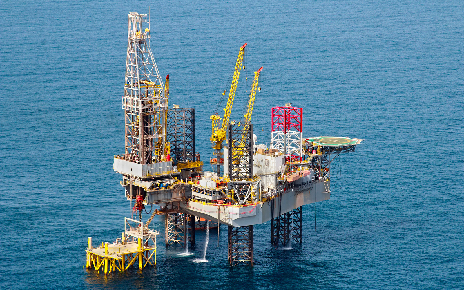 Aerial view of large oil offshore drilling platform surrounded by ocean