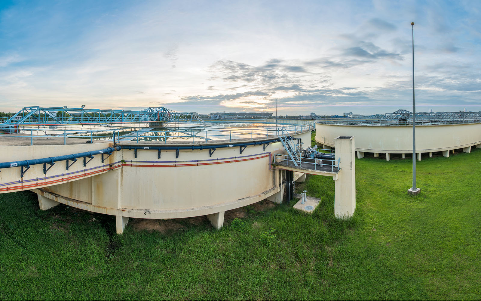 Photo of a water treatment plant under a blue sky