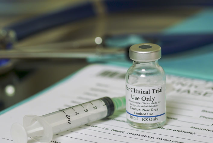 Photo of Clinical Trial use medication and syringe laying on top of a medical form