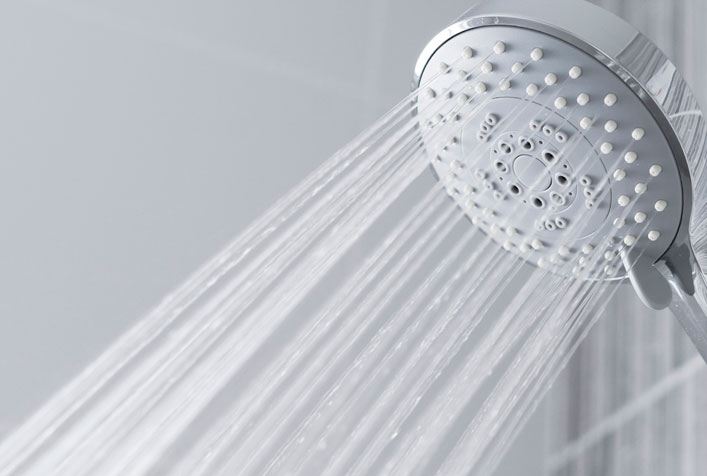 Photo of a shower head spraying water
