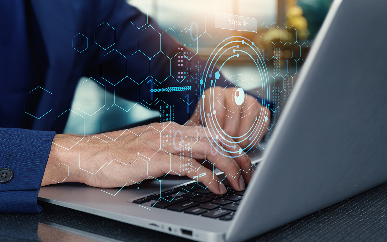 hands typing on a computer overlaid with an image of data