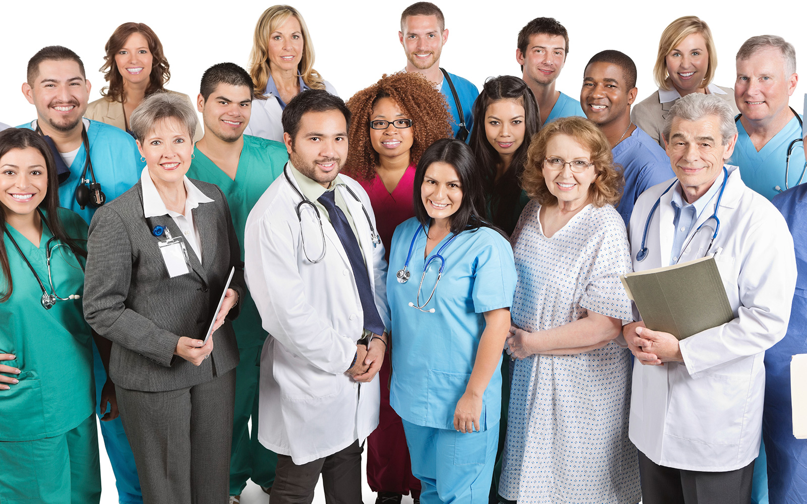 Over a dozen diverse smiling hospital staff and a patient standing together, all looking at the camera. 