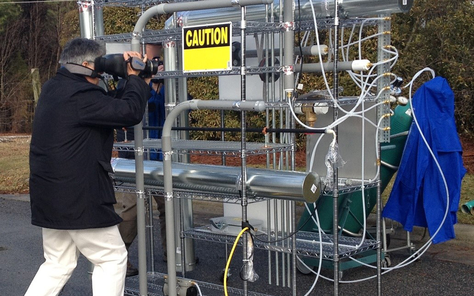 Man operating an optical gas imaging device