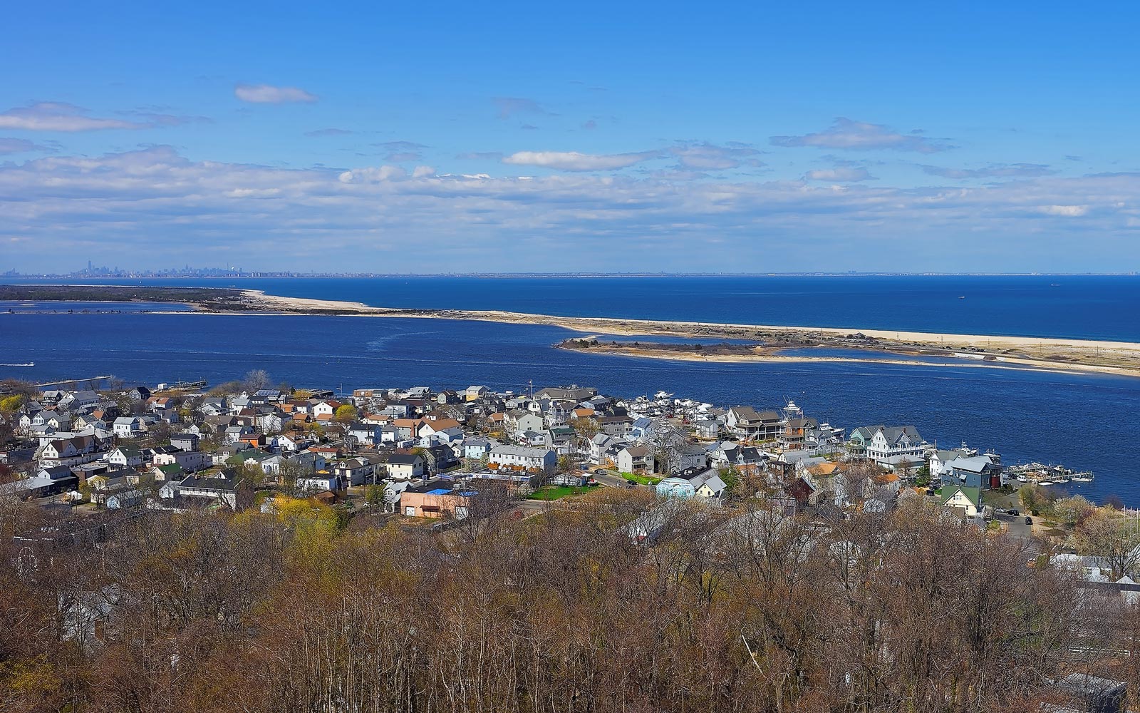 Aerial view of houses, shoreline, and ocean along the U.S. coast.