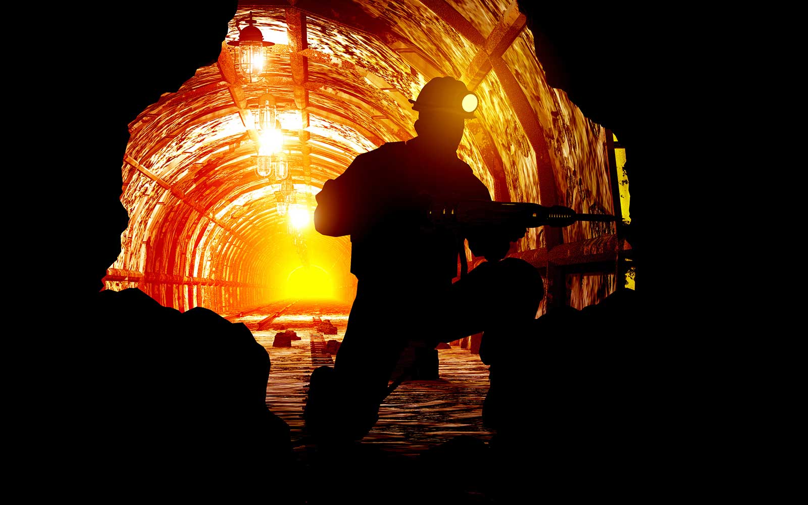 Miner drilling into rock face in a mine.