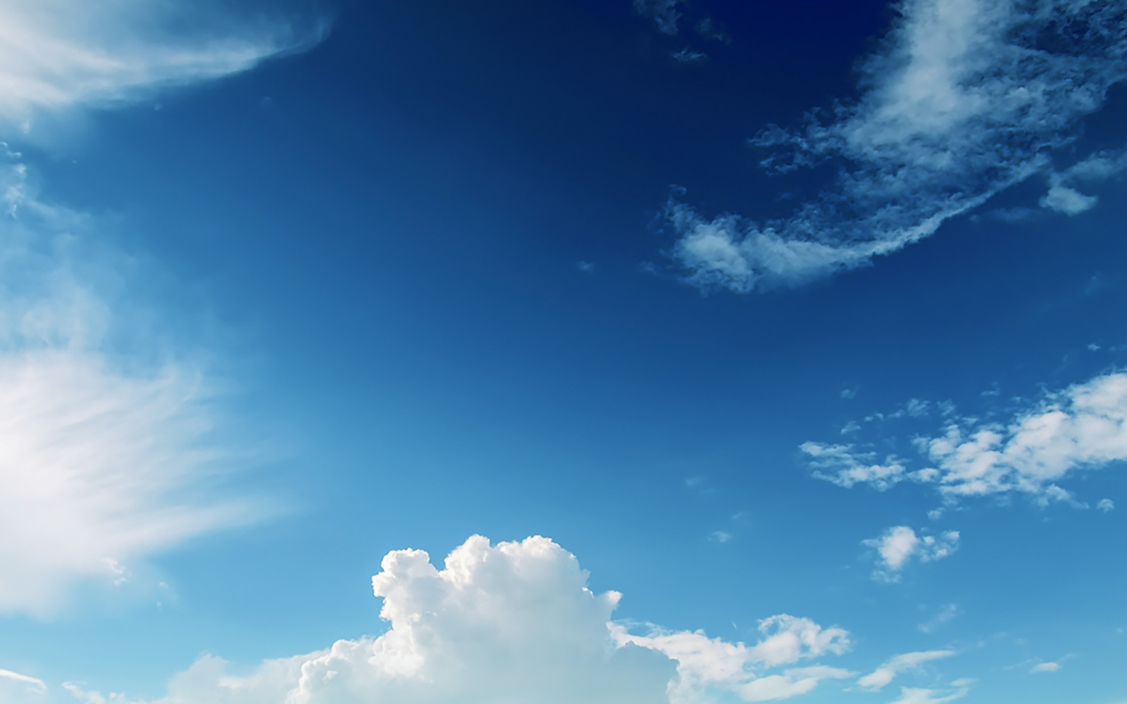 Clear blue sky with puffy white clouds