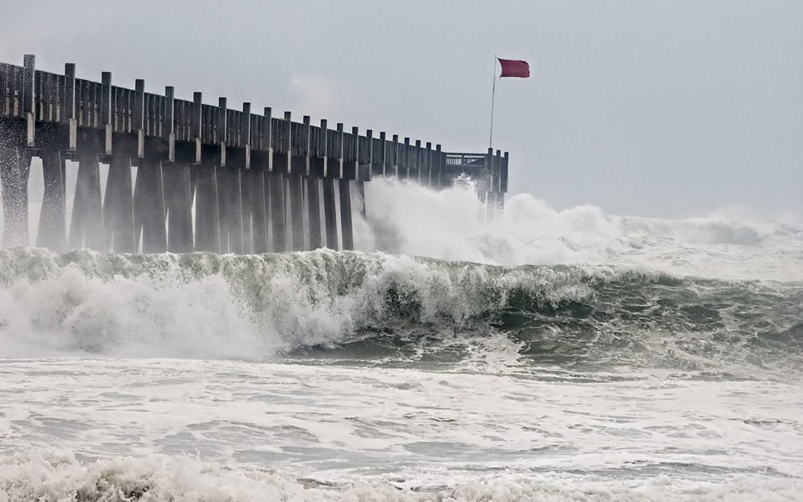 waves crashing into pier