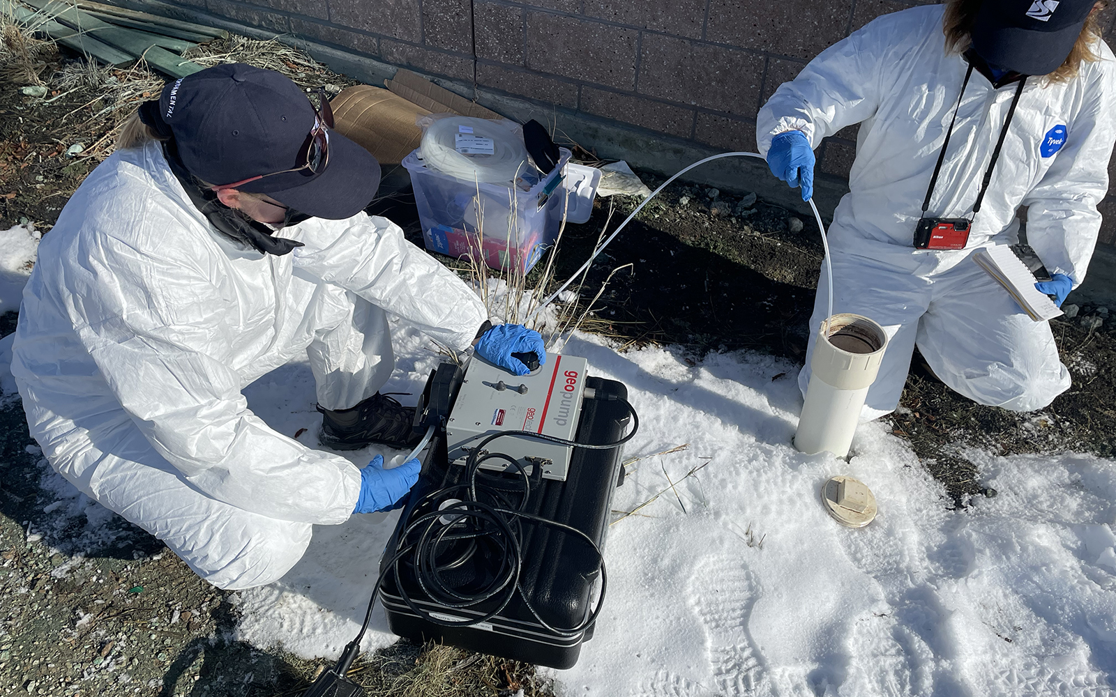 Technicians collecting/testing wastewater samples