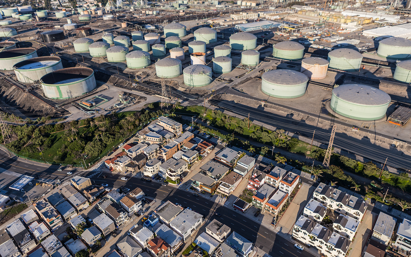 photo of homes and nearby oil tanks