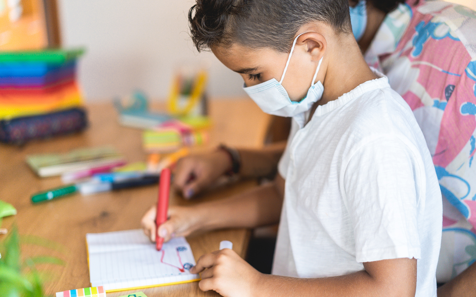 Young boy wearing a mask in daycare setting