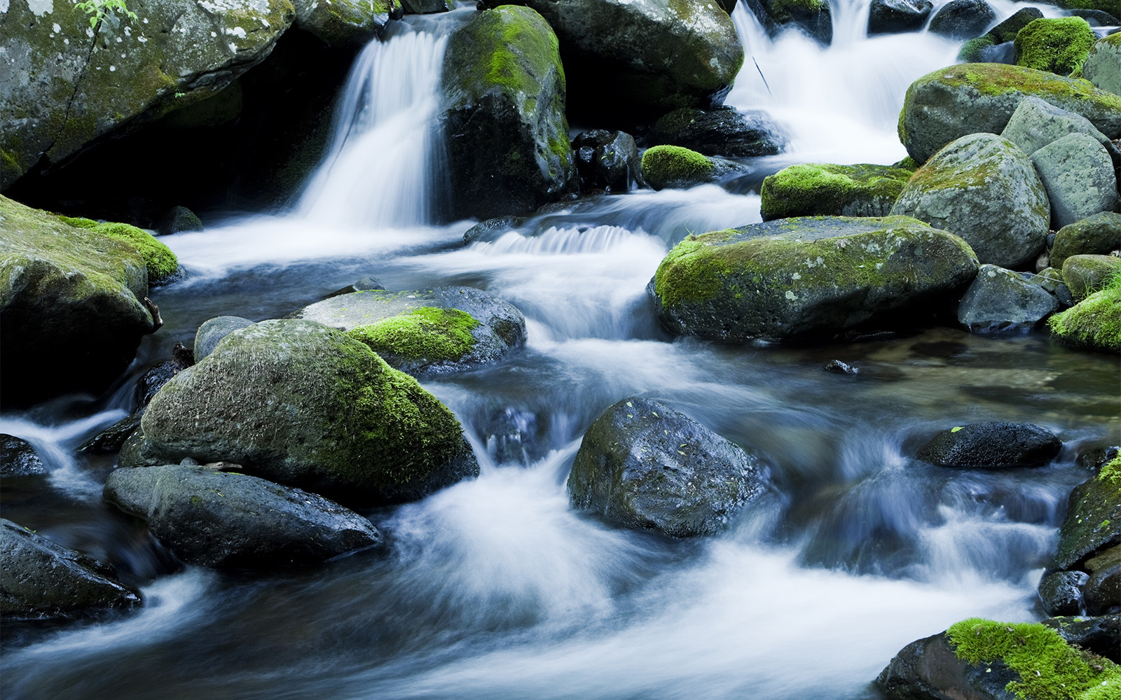 Running water flowing around rocks 