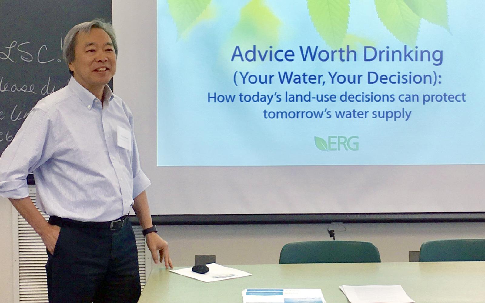 Man in front of presentation about drinking water