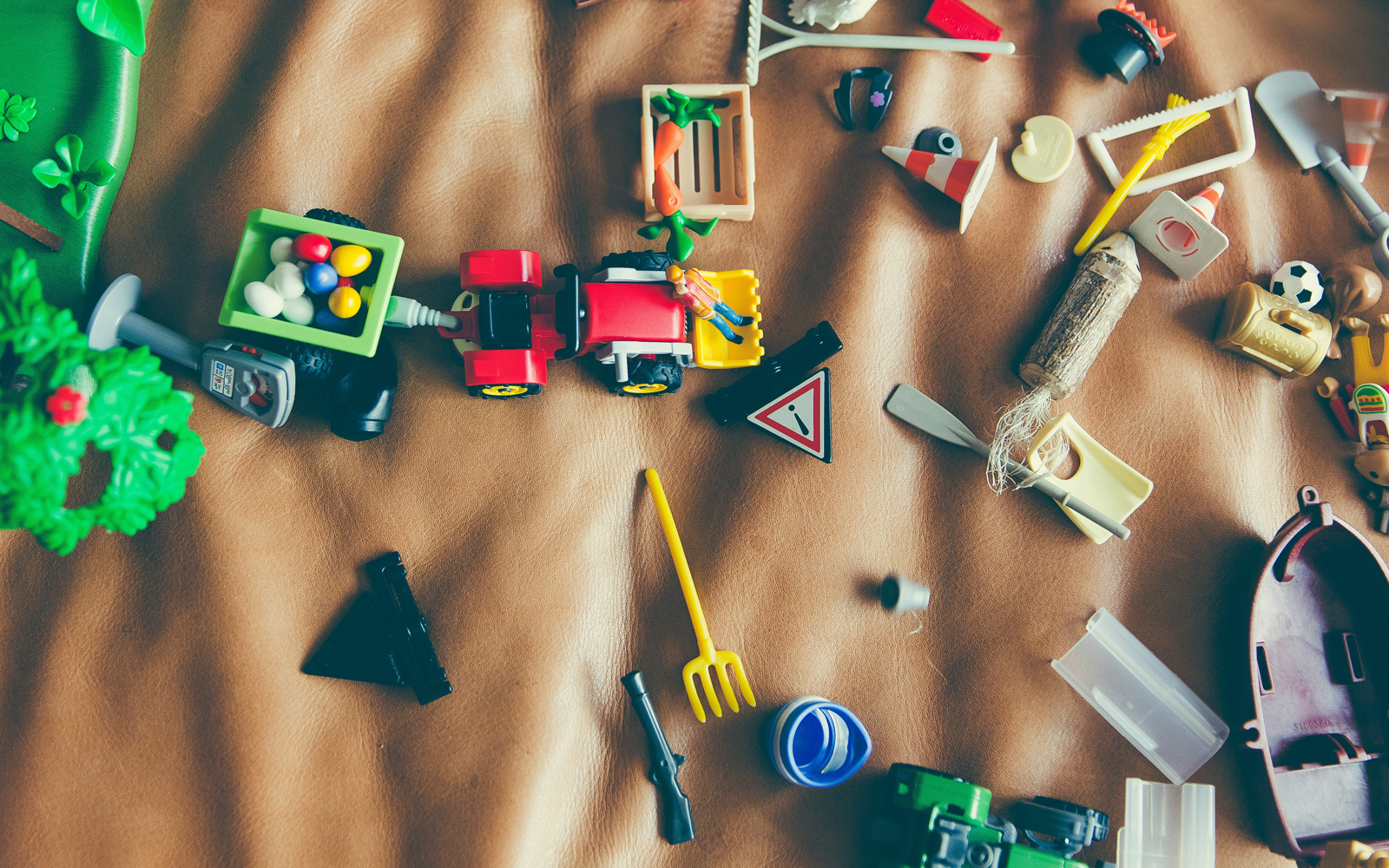 small plastic toys on a brown background.