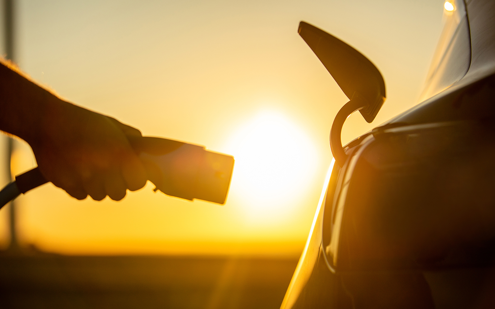 photo of plugging in an electric car charger