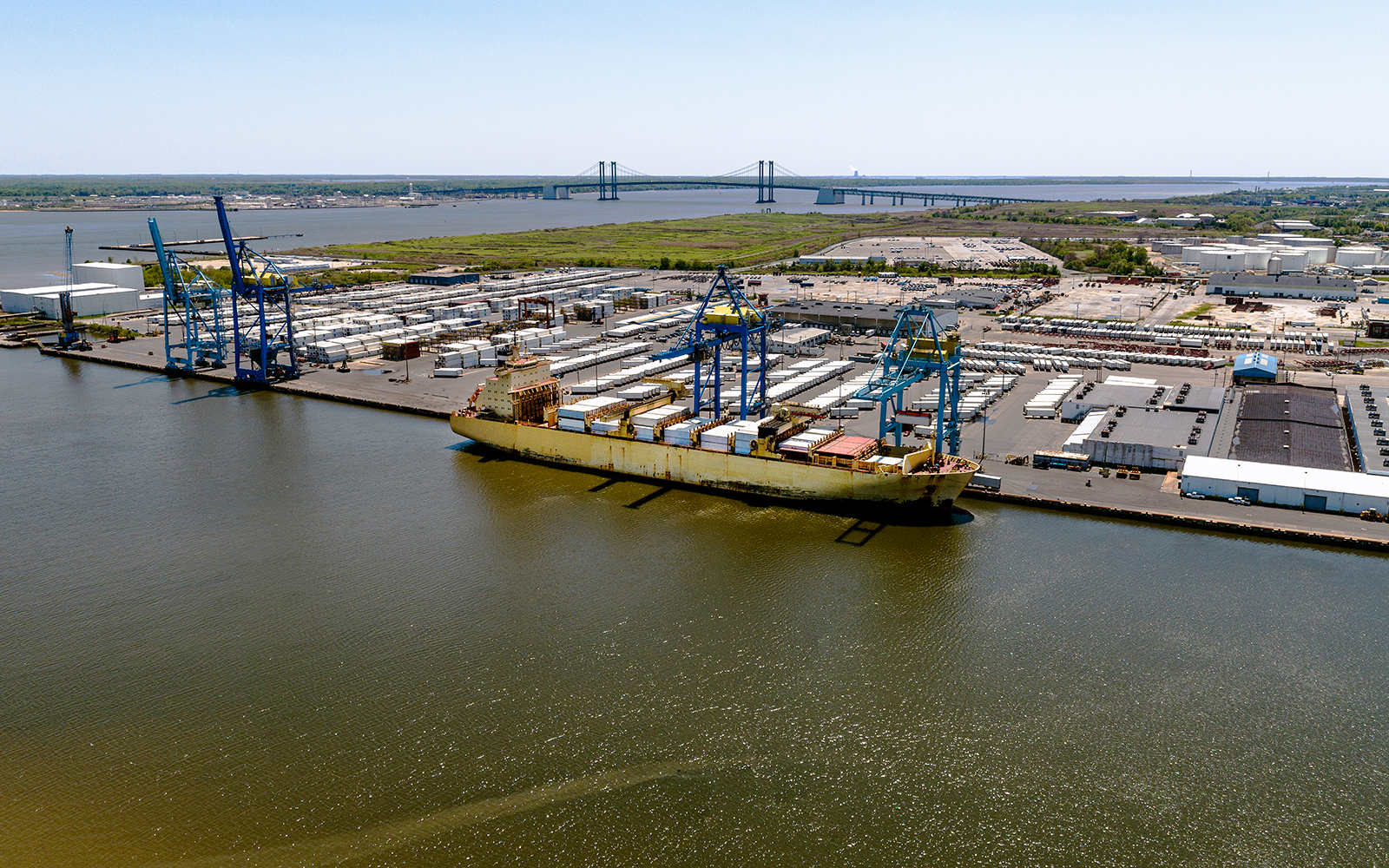 Photo of Port in Wilmington Delaware with a cargo ship at unloading crane