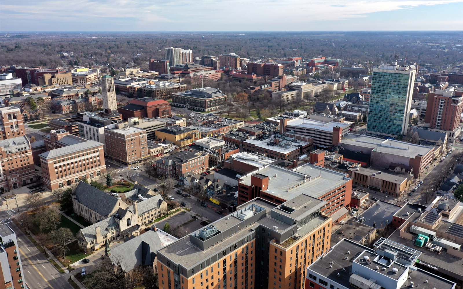 Photo of Ann Arbor, Michigan from above, showing buildings of different sizes, city streets, and the horizon