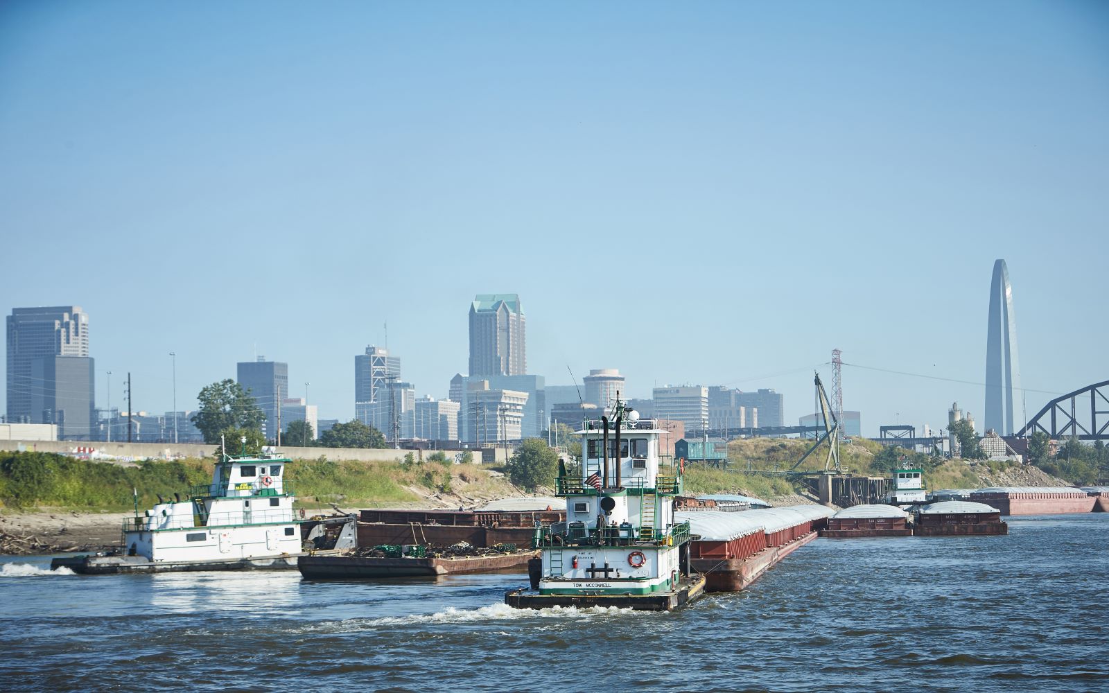 Boats on the St. Louis waterfront with the hazy skyline in the back.
