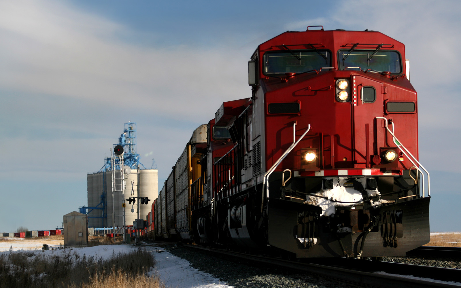 A locomotive train on a track surrounded by snow