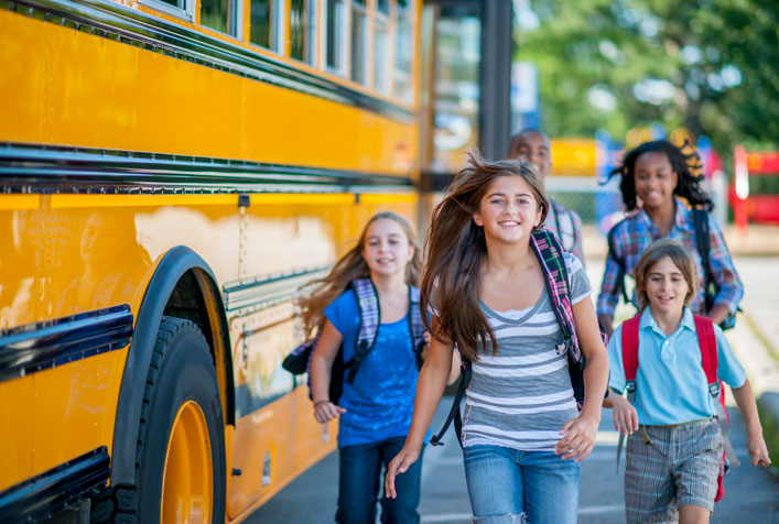 Photo of children outside a school bus