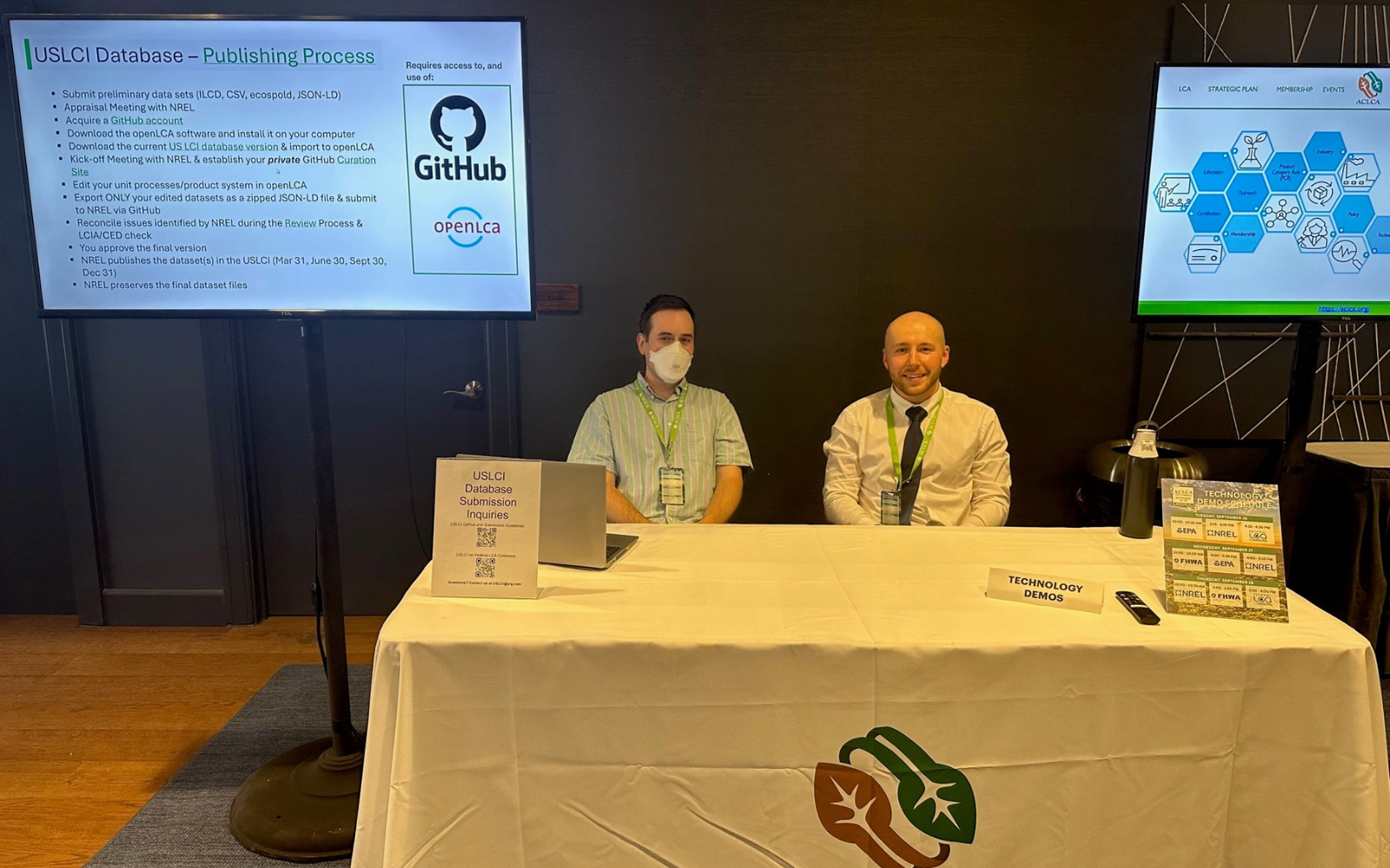 Two ERG employees sit at a table at the ACLCA conference.