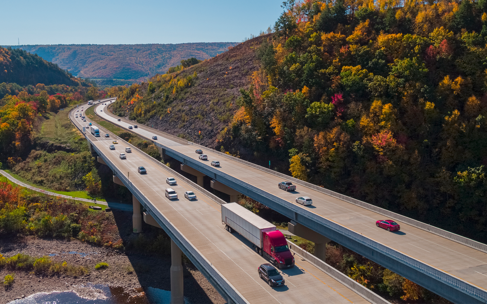 Multiple vehicles driving on a busy highway.