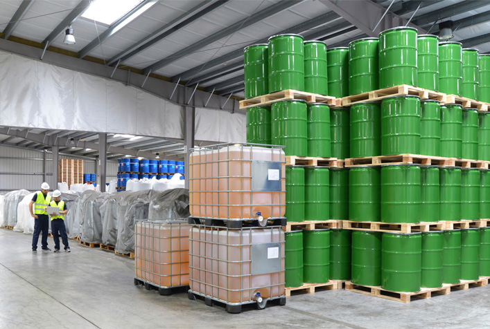photo of stacked storage barrels in a warehouse