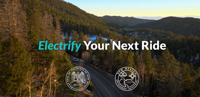The words "electrify your next ride" overlaid on an image of a new mexico road