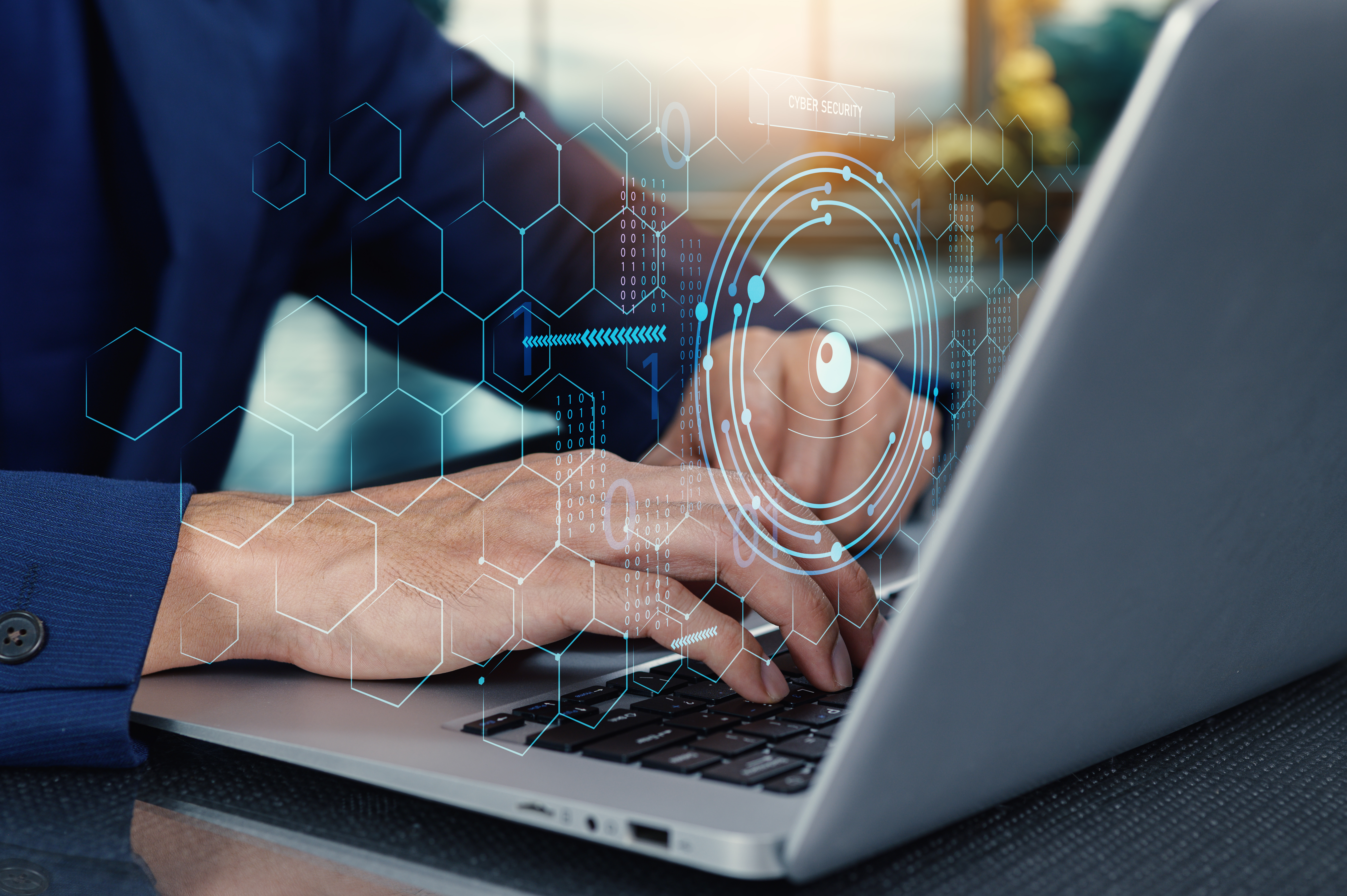 hands typing on a computer overlaid with an image of data