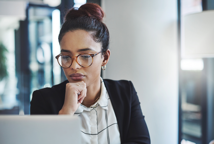 person thinking while looking at a computer screen