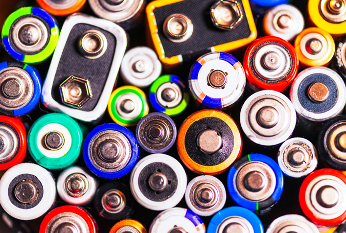 Photo looking down on many batteries of different sizes and colors