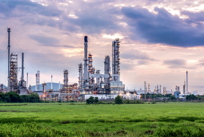 Image of a facility from a distance with many stacks and monitoring equip.
