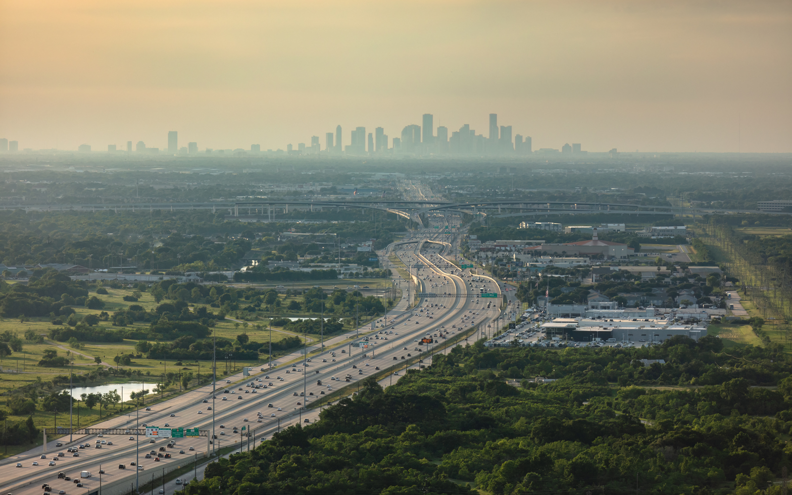 Image of large highway with a cityscape in the background