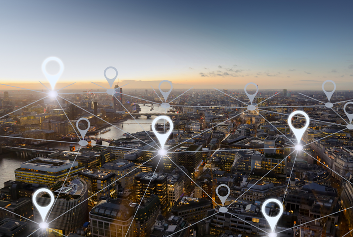 Aerial photo of cityscape overlayed with a graphic symbolizing interconnection of points within the area